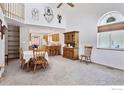 Open-concept living space with vaulted ceilings, flowing into a kitchen and dining area at 2143 Meadow Ct, Longmont, CO 80501