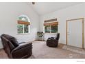 Cozy living area with large windows, comfortable seating, and neutral tones, creating a relaxing atmosphere at 2143 Meadow Ct, Longmont, CO 80501