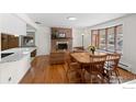 Sun-filled dining room with hardwood floors, fireplace, and backyard view at 255 Iroquois Dr, Boulder, CO 80303