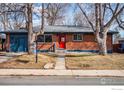 Charming brick home with a bright red front door, blue garage, and well-maintained front yard at 2994 23Rd St, Boulder, CO 80304