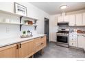 Bright kitchen with stainless steel appliances, white cabinets and floating shelves at 2994 23Rd St, Boulder, CO 80304