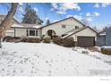 Inviting two-story home with a well-maintained lawn, complemented by a two-car garage covered in fresh snow at 3115 Heidelberg Dr, Boulder, CO 80305