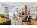 Inviting living room with a fireplace, hardwood floors, and sliding glass door to the exterior at 350 Arapahoe Ave # 10, Boulder, CO 80302