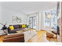 Bright living room with hardwood floors, large windows, and stylish furniture at 350 Arapahoe Ave # 10, Boulder, CO 80302