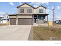 Charming two-story home with a welcoming covered porch and a spacious three-car garage at 4107 Marble Dr, Mead, CO 80504