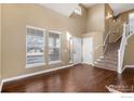 Bright and airy living room with soaring ceilings, hardwood floors, and large windows at 4672 Charing Ct, Castle Rock, CO 80109