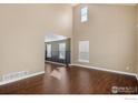 Spacious living room with hardwood floors, neutral walls, and classic wainscoting detail at 4672 Charing Ct, Castle Rock, CO 80109