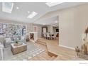 This living room has hardwood floors, large windows, and an open-concept design leading to the dining area at 4760 Mckinley Dr, Boulder, CO 80303