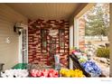 Charming porch with brick accents, decorative touches, and vibrant flowers for a cozy, welcoming ambiance at 5001 Garrison St # 6, Wheat Ridge, CO 80033