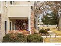 Charming porch with brick accents, decorative touches, and inviting curb appeal with lush greenery at 5001 Garrison St # 6, Wheat Ridge, CO 80033