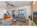 Spacious living area featuring wood floors, a modern sofa, and a cozy fireplace at 525 Manhattan Dr # 104, Boulder, CO 80303