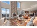 Cozy living room featuring a stone fireplace, wood floors, comfortable seating and sliding doors to outdoor patio at 820 Peakview Rd, Boulder, CO 80302