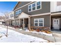 Attractive townhome exterior with a covered front porch and well-maintained landscaping, perfect curb appeal at 891 Winding Brook Dr, Berthoud, CO 80513