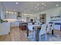 Bright kitchen with stainless steel appliances, pendant lighting, and a dining area for entertaining at 913 Saint Andrews Ln, Louisville, CO 80027