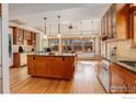 Bright kitchen featuring wood cabinetry, hardwood floors, granite counters, and a central island at 941 8Th St, Boulder, CO 80302