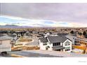 Areal view of a residential neighborhood with mountain views and modern farmhouse style homes at 964 Saint Andrews Ln, Louisville, CO 80027