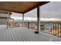 Large deck with iron railings offering scenic views of the neighborhood and distant mountains at 964 St. Andrews Ln, Louisville, CO 80027