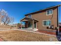 Beautiful backyard featuring a covered patio and well-maintained lawn at 9685 Bellaire Ln, Thornton, CO 80229