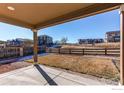 Spacious backyard with a covered patio, perfect for outdoor entertaining and relaxation at 9685 Bellaire Ln, Thornton, CO 80229