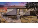 Charming single-Gathering home with tidy lawn and concrete walkway leading to the front door and a brown shingle roof at 972 S Zeno Way, Aurora, CO 80017