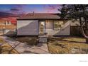 Single Gathering house exterior with landscaping in a suburban neighborhood during a colorful sunset at 972 S Zeno Way, Aurora, CO 80017