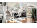 Bright living room featuring vaulted ceilings, fireplace, and modern finishes with staircase to loft area at 972 S Zeno Way, Aurora, CO 80017