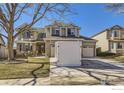 Charming two-story home featuring a well-manicured lawn and a spacious two car garage at 9757 Kipling St, Broomfield, CO 80021