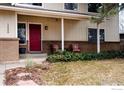 Inviting front porch with cozy seating and a red front door at 1400 Athene Dr, Lafayette, CO 80026