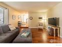 Open-concept living room with hardwood floors and a view of the staircase at 1400 Athene Dr, Lafayette, CO 80026