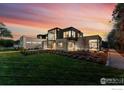 Stunning modern home with meticulous landscaping, stone accents, and expansive windows at sunset at 1590 Sumac Ave, Boulder, CO 80304