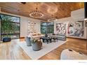 Bright living room featuring hardwood floors, large windows, stylish lighting, and modern decor at 1590 Sumac Ave, Boulder, CO 80304