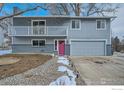 Charming two-story home with a balcony, brick facade, and a two-car garage at 1714 Zeus Dr, Lafayette, CO 80026