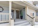 Inviting front porch with gray siding, brown door, and neutral trim welcomes you home at 1944 Arapahoe Ave # C, Boulder, CO 80302