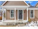 Inviting front entrance featuring a decorative door, white pillars, and a covered porch, adding curb appeal to the home at 195 S Cleveland Ave, Louisville, CO 80027