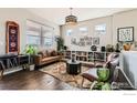 Cozy living room with hardwood floors, stylish furniture, and plenty of natural light at 2289 French Cir, Longmont, CO 80504