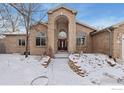 Stunning entryway featuring a grand arched entrance and brick facade at 232 Elizabeth Ct, Fort Lupton, CO 80621