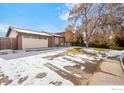 View of a well-maintained home with a two-car garage, updated driveway, and mature tree providing shade at 2962 E 96Th Pl, Thornton, CO 80229