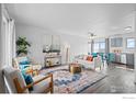 Inviting living area with stylish furnishings, a colorful rug, and bright light, creating a cozy and airy ambiance at 2962 E 96Th Pl, Thornton, CO 80229