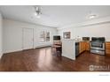 This open living room features hardwood floors, modern appliances, and a cozy feel for modern living at 3380 Folsom St # 115, Boulder, CO 80304