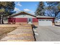 Home exterior featuring a spacious deck, attached garage, and front yard at 3401 Meining Rd, Berthoud, CO 80513