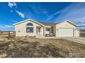 Well-maintained one-story home featuring a manicured lawn, large windows, and a two-car garage at 4700 Karen Ct, Berthoud, CO 80513