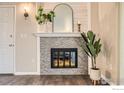 Close-up of the fireplace, with decor, tiled surround and white painted trim at 60 S Boulder Cir # 6015, Boulder, CO 80303