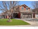 Charming two-story home with red siding and stone accents at 602 S 34Th Ave, Brighton, CO 80601