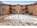 Condo complex showcases symmetrical wooden stairways and sparse landscaping at 6118 Habitat Dr # 1, Boulder, CO 80301