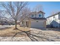 Charming two-story home with a two-car garage and well-maintained front yard at 6924 Quigley Cir, Firestone, CO 80504