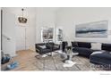 Bright living room featuring vaulted ceilings, wood floors, and contemporary decor at 6924 Quigley Cir, Firestone, CO 80504