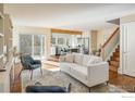 Bright living room with wood floors, stylish furniture, and open layout to the kitchen at 780 Utica Ave, Boulder, CO 80304