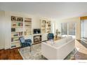 Open living room featuring a fireplace, built-in shelves, hardwood flooring, and natural light at 780 Utica Ave, Boulder, CO 80304