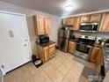 This kitchen features stainless steel appliances, wooden cabinets, and tile floors at 805 29Th St # 204, Boulder, CO 80303