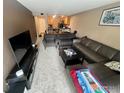 The living room features a large sectional, gray armchairs, and neutral carpet at 805 29Th St # 204, Boulder, CO 80303